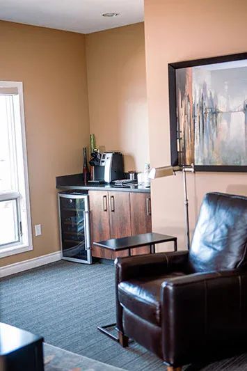 A quiet room with a leather recliner and a coffee corner