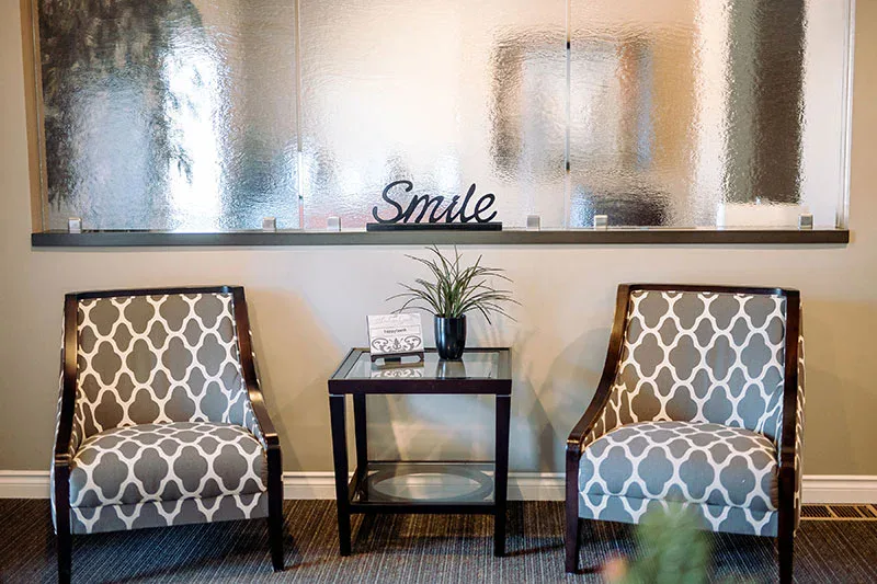 Two armchairs under the Smile sign