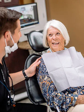 A patient laughing with her dentist