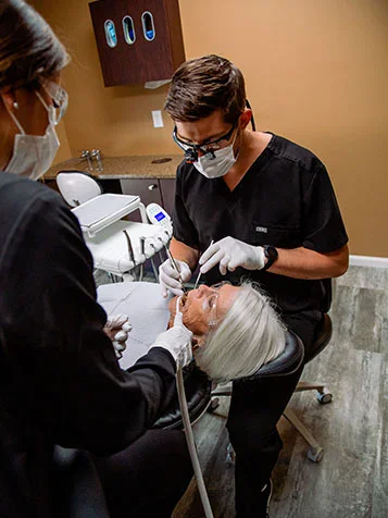 A dentist and assistant treating a patient